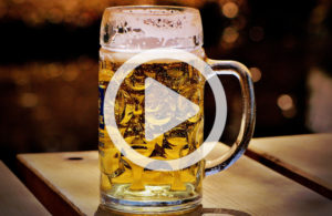 Full beer mug with play button icon